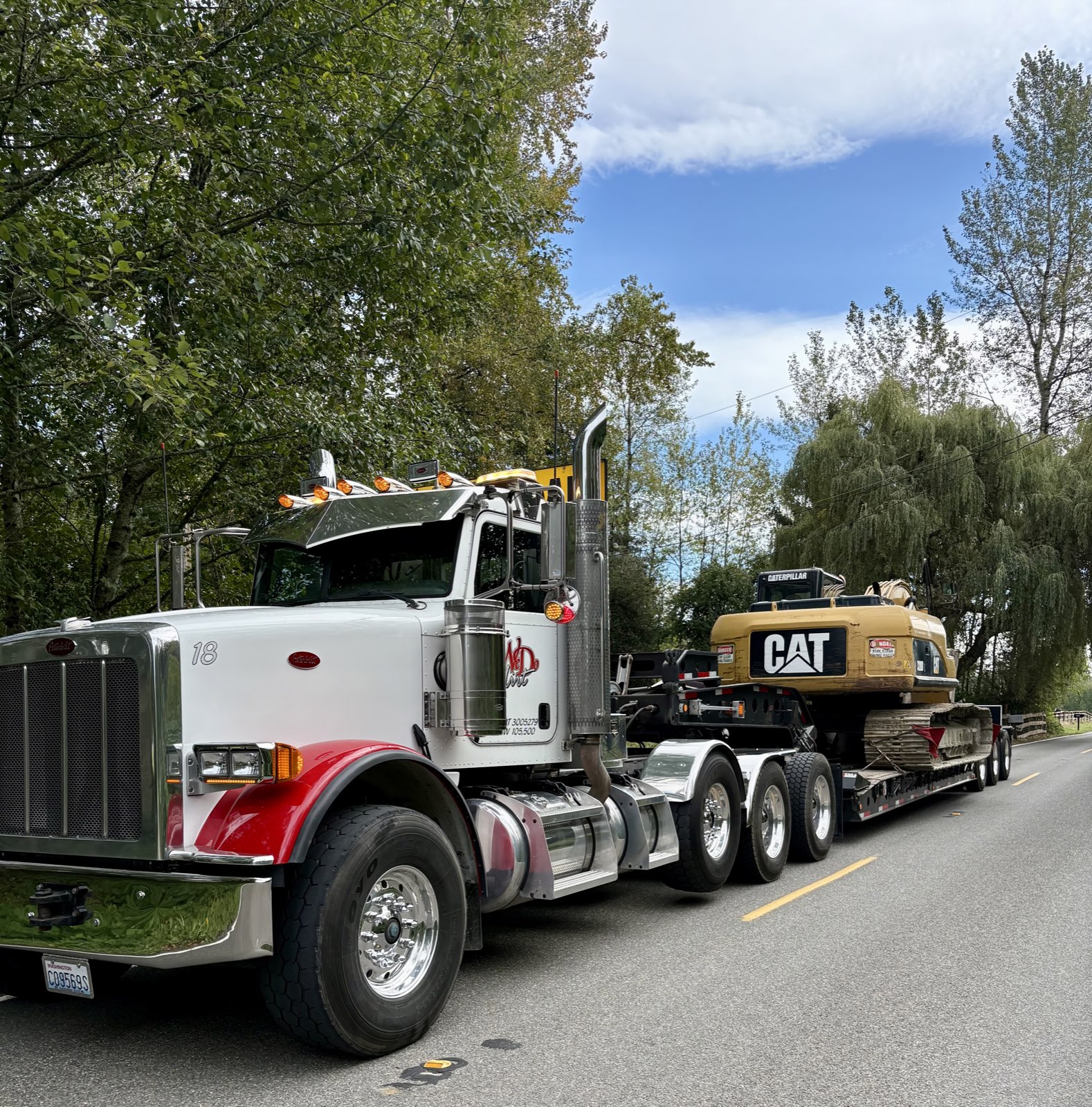 WD Dirt Peterbilt hauling CAT excavator on lowboy