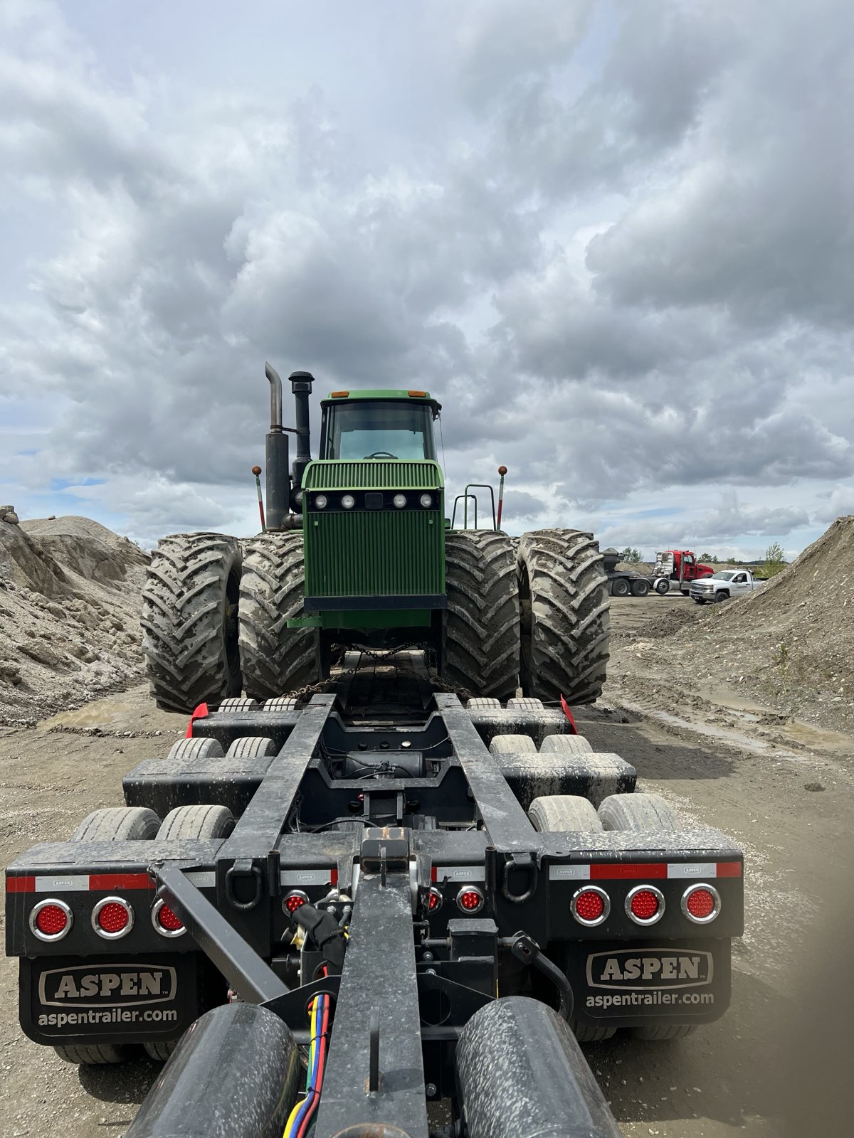 Steiger 4WD tractor loaded on Aspen lowboy trailer